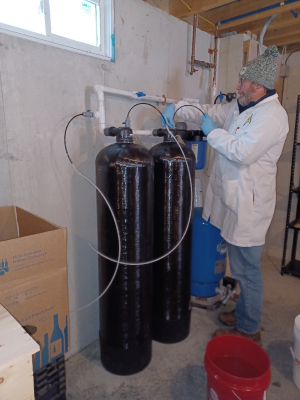 DEP staff collecting water samples from a treatment system