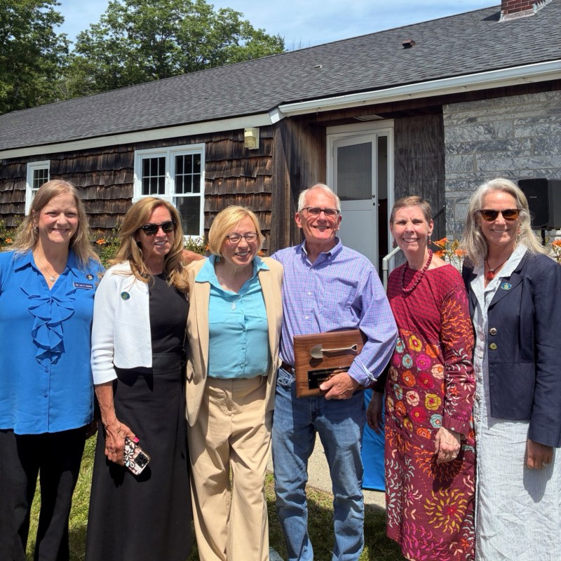 Governor Mills with five people flanking her to the right and left