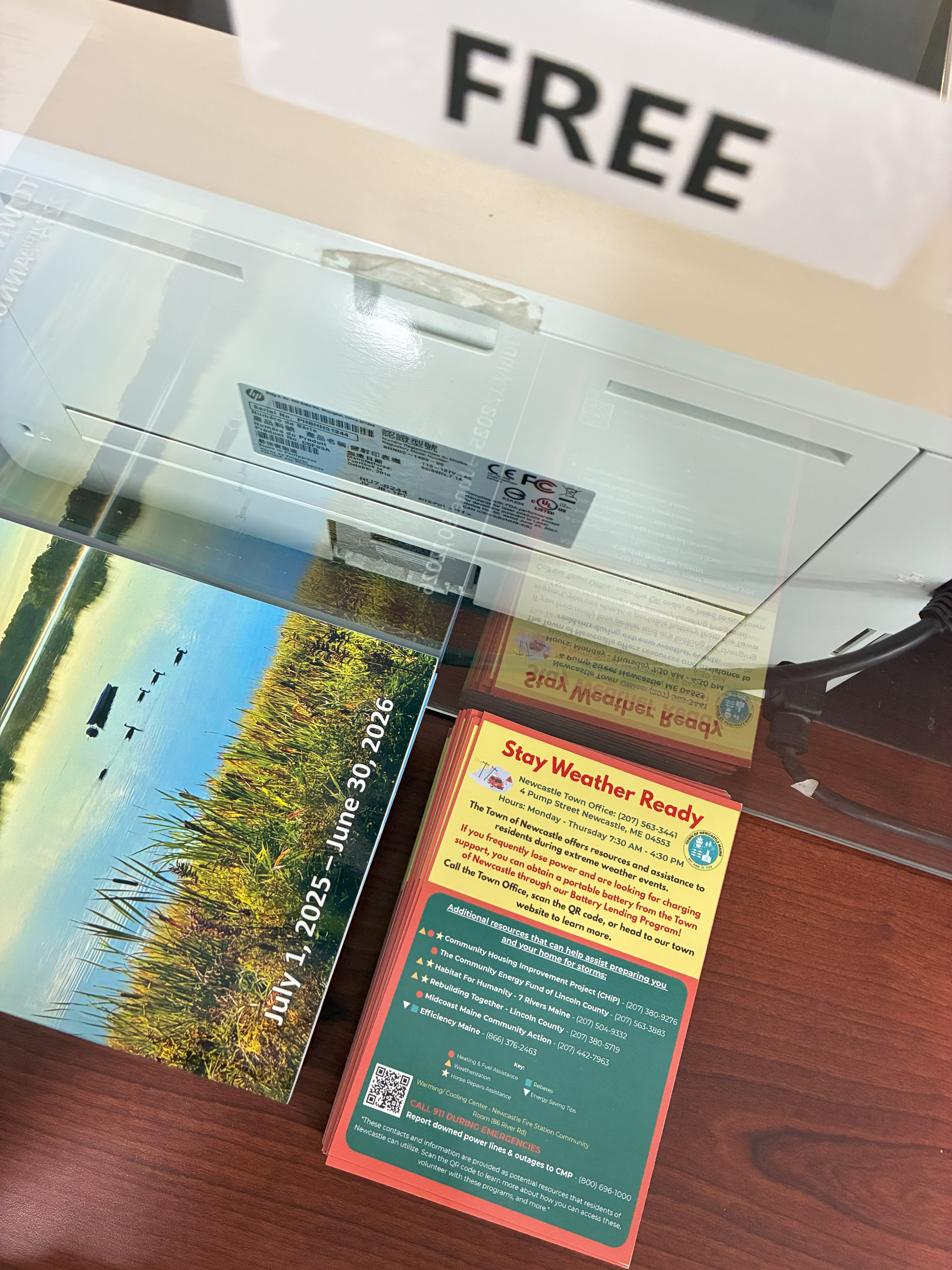 A stack of magnets and pamphlets under a sign that reads "FREE."